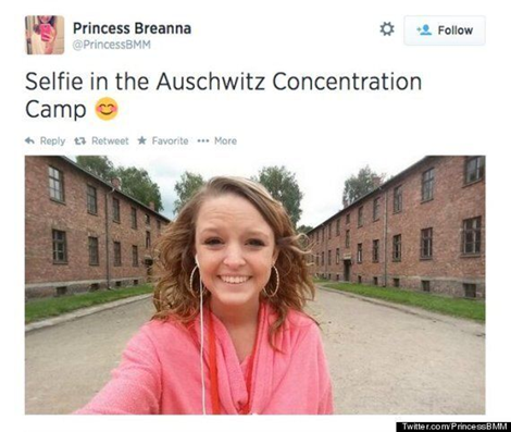 Screenshot of tweet: Username: Princess Breanna. Text: Selfie in the Auschwitz Concentration Camp. Smiley emoji. Photo: A teenage girl smiles for a selfie with brick barracks behind her.