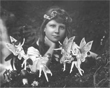 A composite photo: a girl poses amongst the fairies.