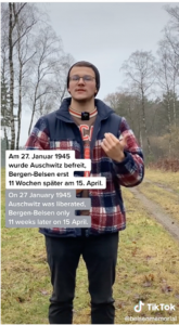 Screenshot of a different young man in front of a field. Text in English and German is the same. English says: On 27 January 1945 Auschwitz was liberated. Bergen-Belsen only 11 weeks later on 15 April.