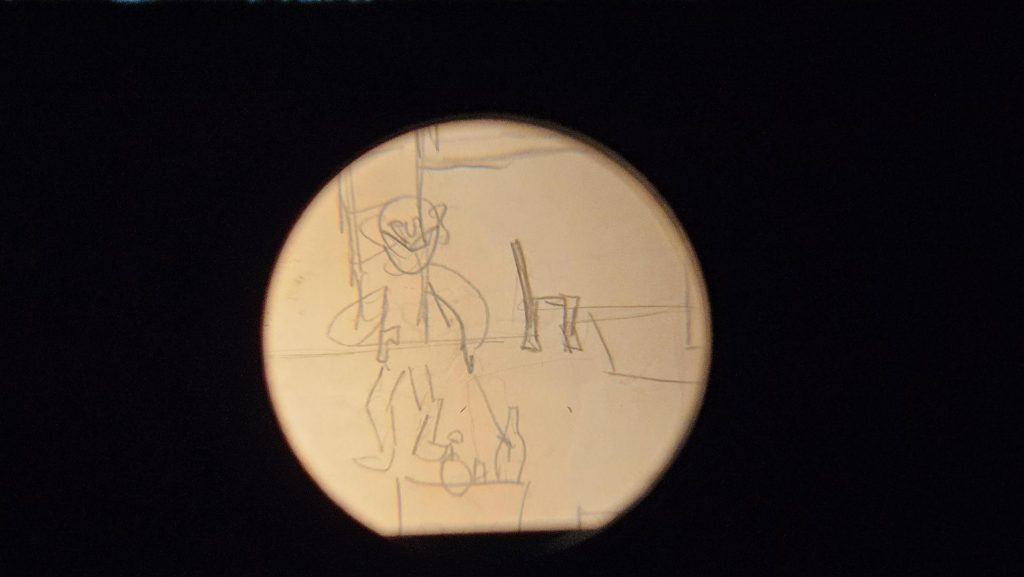 A scribbled children's drawing of a person surrounded by furniture, under a magnifying glass.